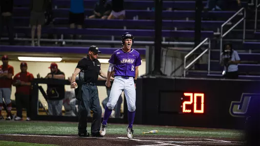 Jack Anderson jumps in the air in celebration at home plate, scoring the winning run against Louisiana at Veterans Memorial Park.