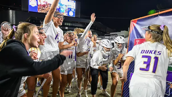 JMU Lacrosse celebrates after defeating ECU in the 2026 American Conference Women's Lacrosse Championship