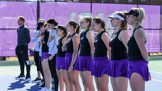 JMU women's tennis stands for the national anthem prior to its match versus Richmond.