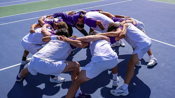 JMU huddles for a pre-match chant prior to facing George Mason on Senior Day
