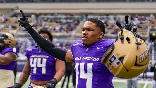 KJ Flowe with his helmet off, pointing his fingers in the air during the Spring Game.