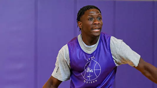 Ace Meeks plays defense during a JMU basketball practice