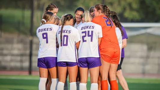 JMU Womens soccer huddles during its match with NC State