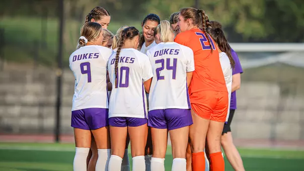 JMU Womens soccer huddles during its match with NC State