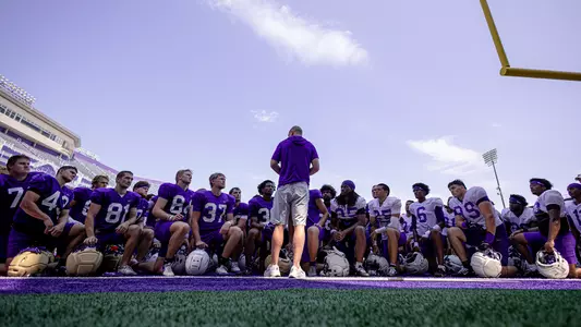 Billy Napier speaking to the team in the endzone after practice at Bridgeforth Stadium.