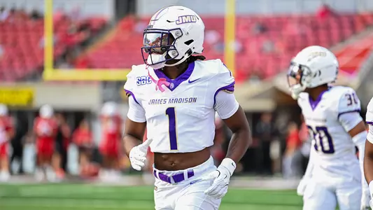 Mekhi Rodgers running on Louisville's field during pregame.