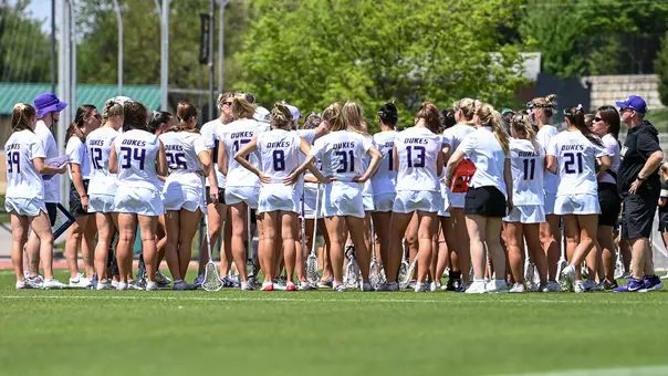 JMU Lacrosse huddles after its match against Vanderbilt