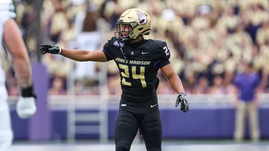 Jayon Harvey signals to his teammates ahead of the snap against Wagner