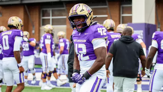 JT Kouame-Yao celebrates ahead of JMUs game against Liberty