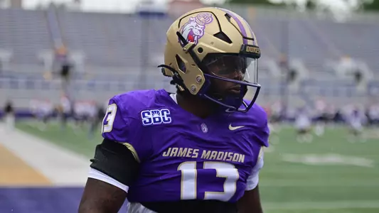 KD Mosley warms up ahead of JMU's game against Liberty