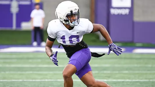 Jase Rhodes drops into coverage during a JMU football practice