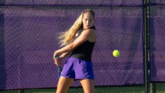 Ariel Avidan returns a serve during a JMU tennis practice