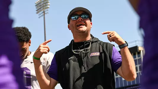 Brandon Bailey instructs the safeties during a JMU football practice