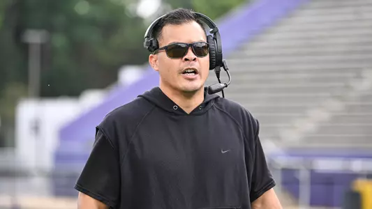 Robert Bala coaches the defense during a JMU football practice