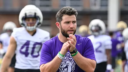 Matthew Josephson instructs the team during a JMU football practice