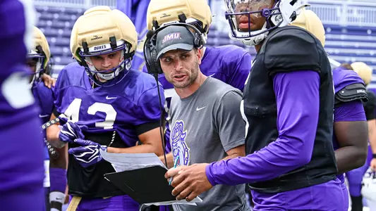 Aaron Pflugrad coaches the offense during a JMU football scrimmage