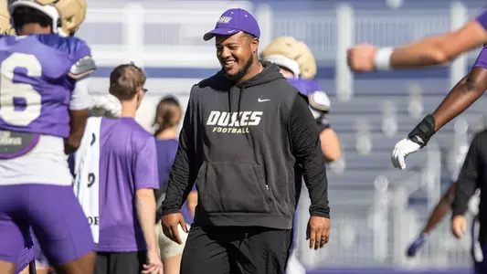 Taylor Powell coaches the defensive line during a JMU football practice