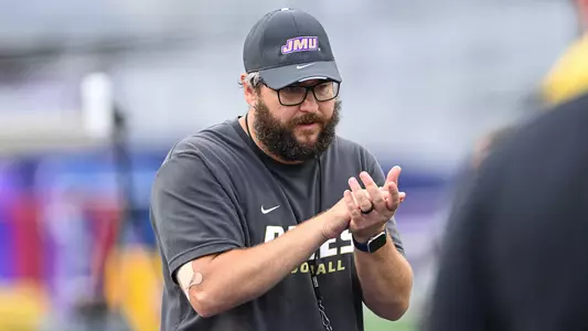 William Peagler coaches the running backs during a JMU football practice