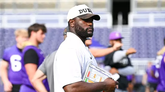 Jireh Wilson coaches during a JMU football practice