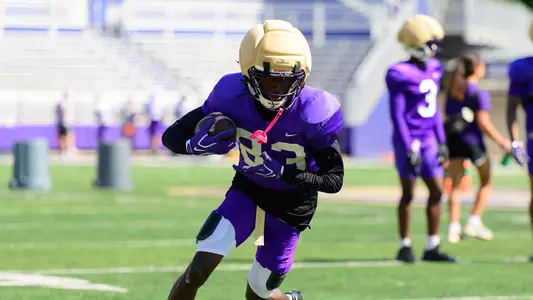 Xavier McDonald makes a catch and run during a JMU football practice