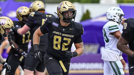 Thatcher Miller head to the sideline after JMU scores a touchdown against Liberty