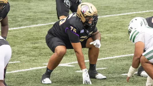 Frankie Tinilau lines up at the line prior to a snap against Wagner