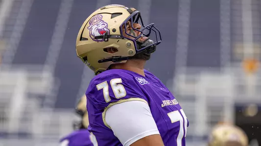 Frankie Tinilau celebrates prior to JMU's game against Liberty