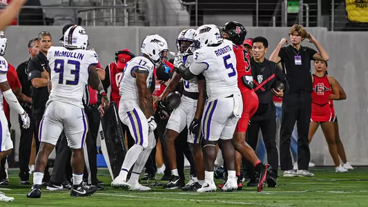 DJ Kelly celebrates with teammates after his interception at San Diego State on Sept. 19.