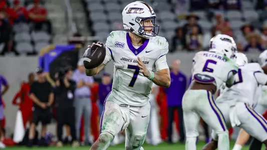 Camden Coleman scrambles and looks downfield at San Diego State