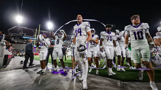 Thomas Guillemette celebrating in front of JMU fans after beating San Diego State at Snapdragon Stadium.