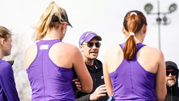 Women's Tennis Coach Tyson Thomas speaking to his team during a match against VCU.