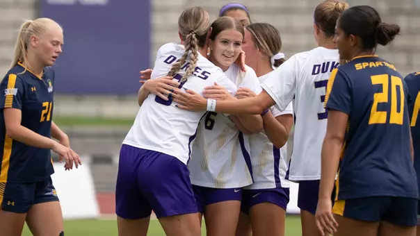 Holly Minshull celebrates with JMU after scoring a goal against UNCG
