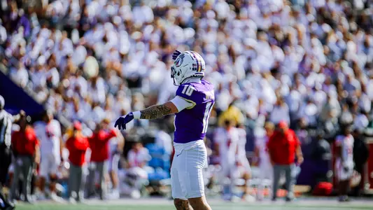 Braeden Wisloski on the field with the White Out crowd behind him at Bridgeforth Stadium.