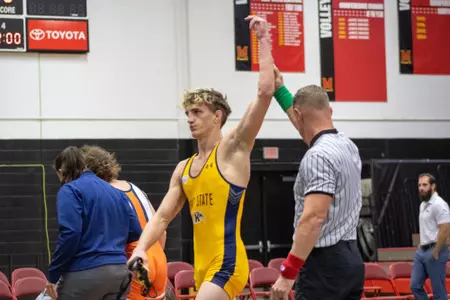 Ethan Barr gets his hand raised falling a match