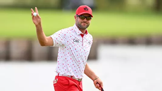 Corey Conners of Team Canada reacts to the crowd at the 18th green during the final round of the 2024 Paris Olympics at Le Golf National on August 4, 2024 in Saint-Quentin-en-Yvelines, Ile-de-France. (Photo by Tracy Wilcox/PGA TOUR/IGF)