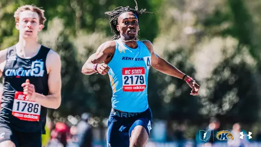 Kent State track and field athlete Micah Coates, wearing bib number 2179, drives hard down the track at the NC State Raleigh Relays, pulling ahead of a competitor from Cincinnati in a sprint event.