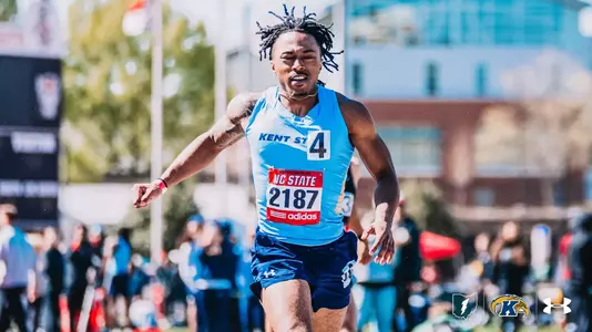 Kent State sprinter Zavion Mattox, wearing a light blue uniform and bib number 2187, lunges across the finish line at the NC State Raleigh Relays.