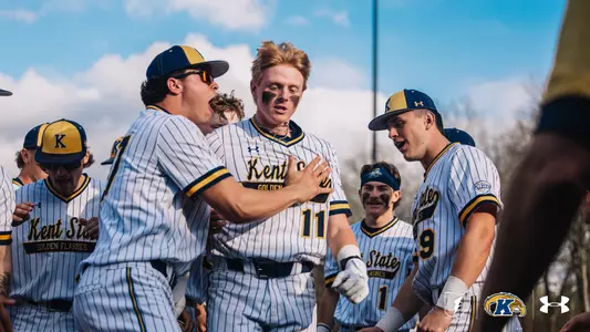 Kolton Schaller with teammates in the dugout