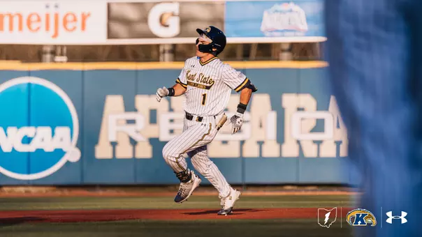Kent State Golden Flashes baseball player wearing No. 1 rounds the bases in a white pinstripe uniform, batting helmet, and batting gloves, with an NCAA logo and stadium signage visible in the background.
