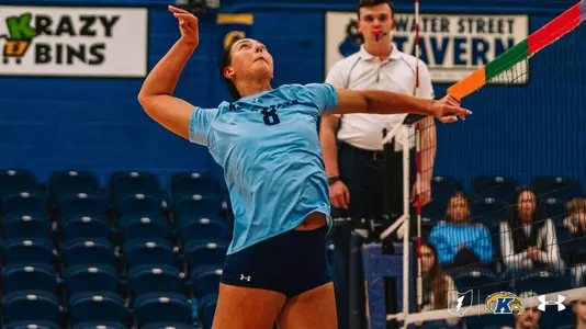 Kent State volleyball player No. 8 Nadia Miller winds up for a serve during a match at the M.A.C. Center, right arm extended with eyes fixed upward toward the ball.