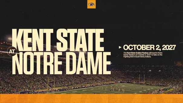 Schedule announcement graphic featuring 'Kent State at Notre Dame – October 2, 2027' in large cream bold text over a dark aerial photo of Notre Dame Stadium packed with fans, with the Kent State Golden Flashes logo at the top center, a brief description of the matchup at right, and a gold bar along the bottom.