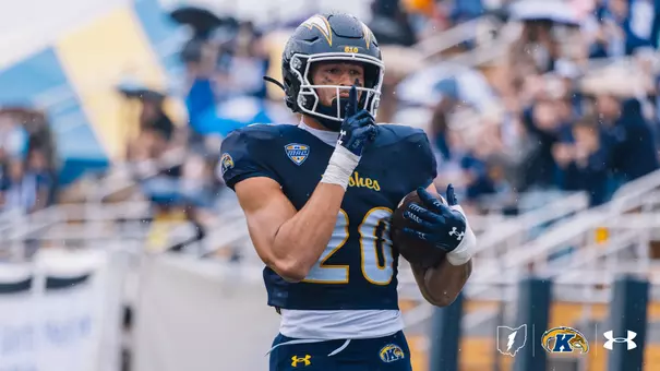 Kent State Golden Flashes college football player wearing jersey number 20 and a dark blue helmet featuring gold lightning bolt decals and a MAC conference logo on the jersey.