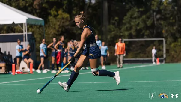 Torie Del Collo striding down the field into UMass' territory with the ball in her possession