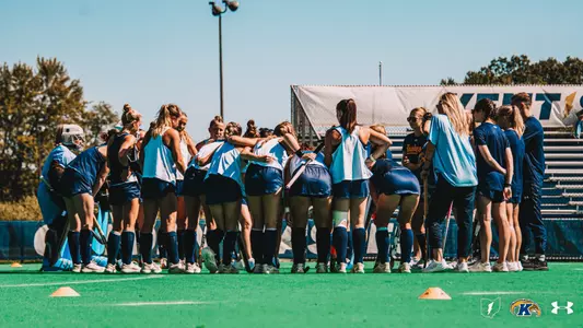 Field Hockey team huddling around pregame vs UMass