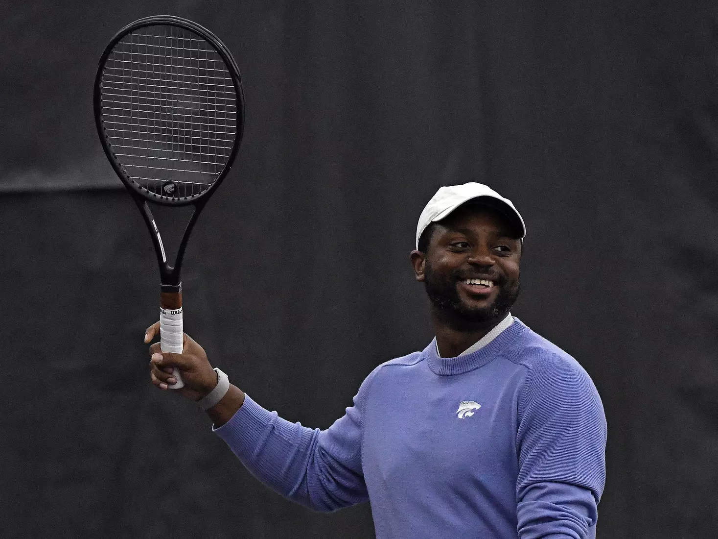 K-State’s coach Jordan Smith directs the Wildcats against Memphis at the Body First Indoor Tennis Center in Manhattan, Kansas on February 11, 2022.