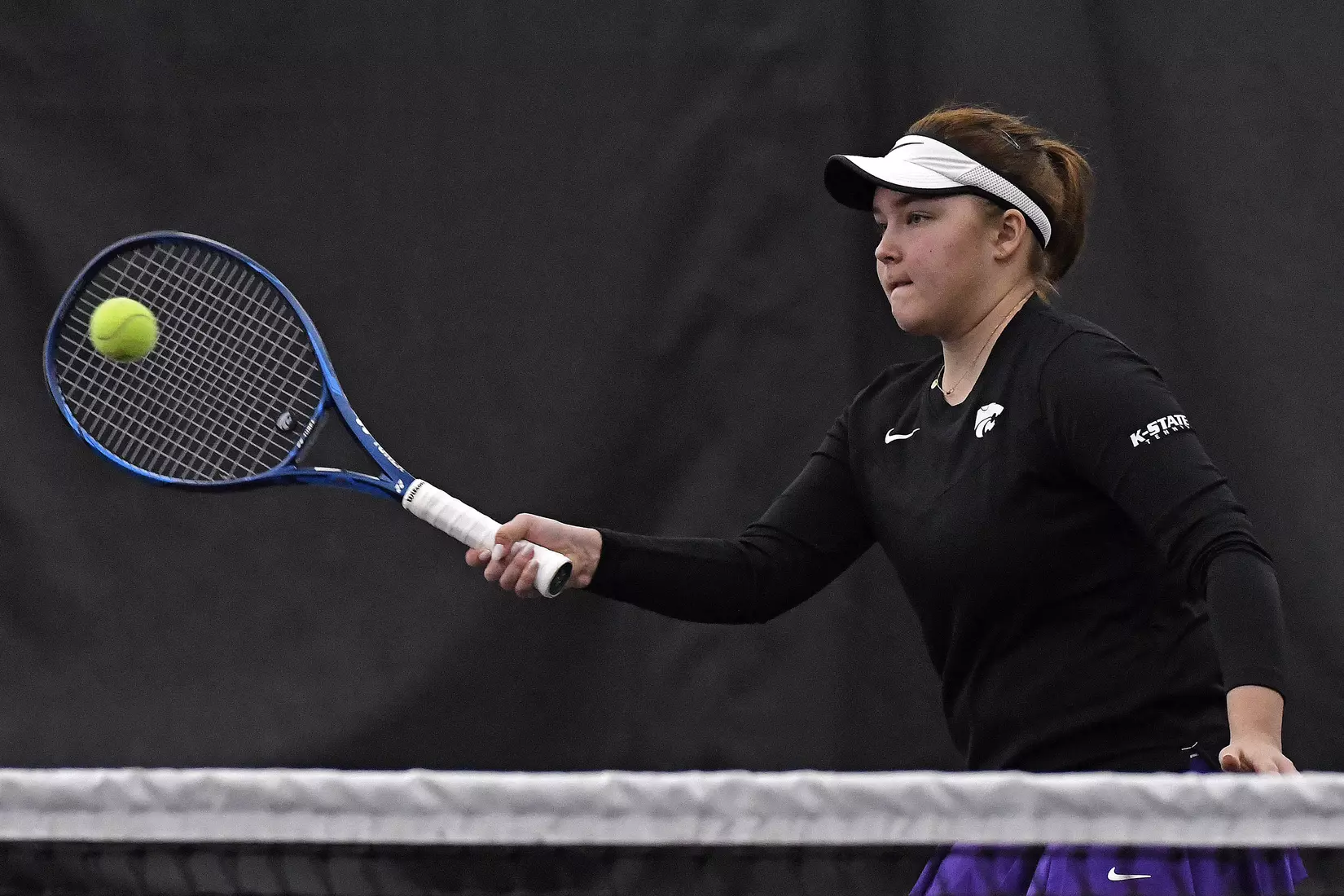 K-State’s Dinara Alloyarova competes against Memphis at the Body First Indoor Tennis Center in Manhattan, Kansas on February 11, 2022.
