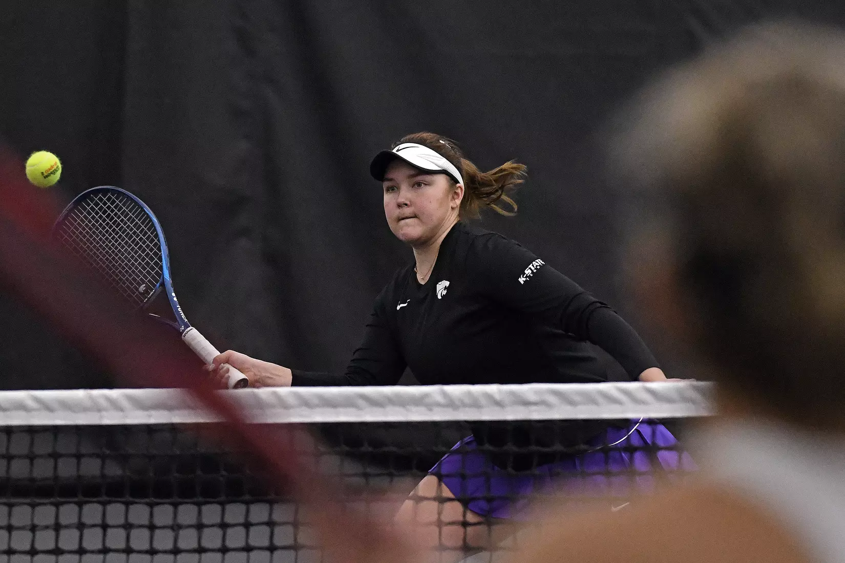K-State’s Dinara Alloyarova competes against Memphis at the Body First Indoor Tennis Center in Manhattan, Kansas on February 11, 2022.