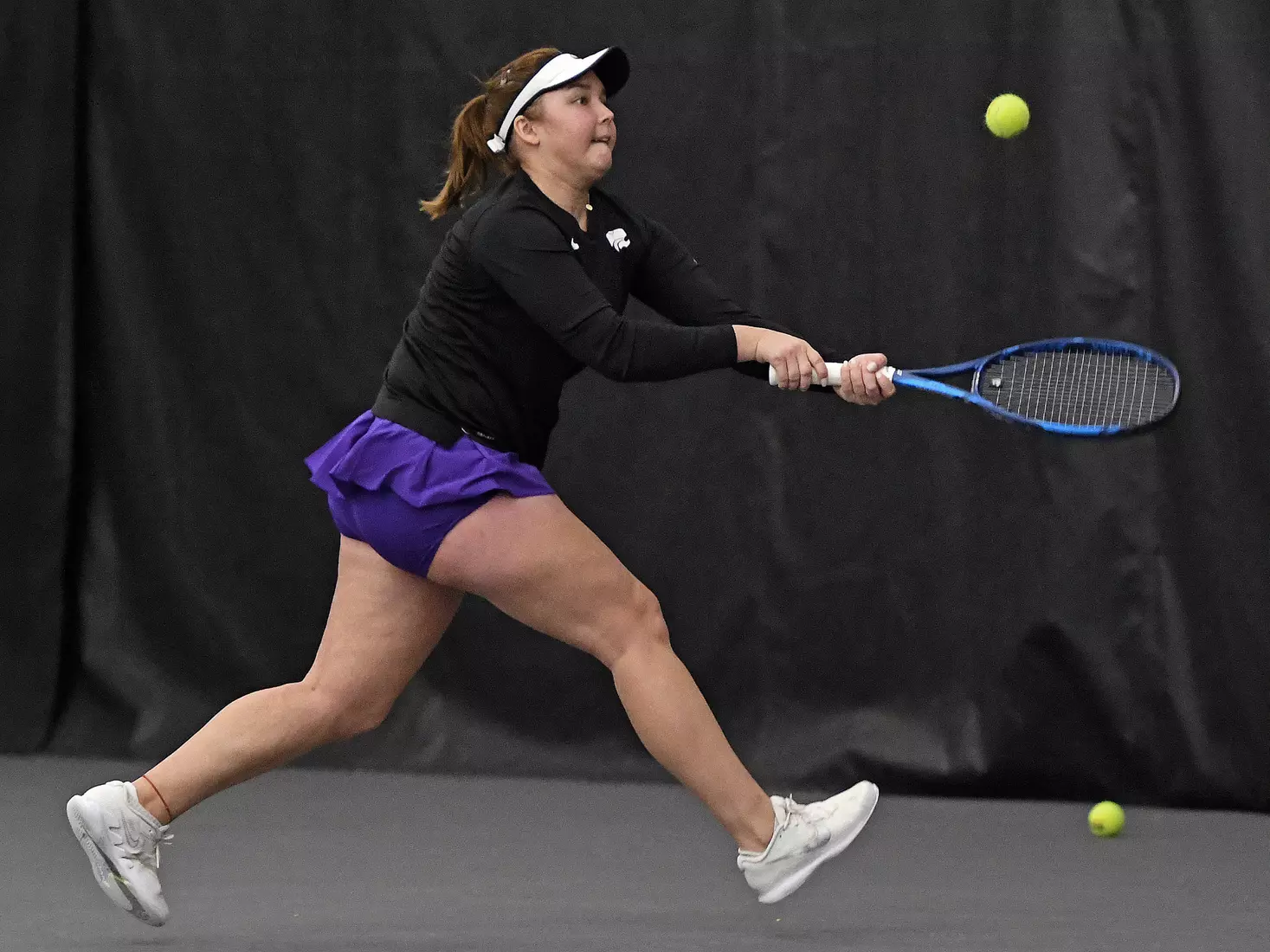 K-State’s Dinara Alloyarova competes against Memphis at the Body First Indoor Tennis Center in Manhattan, Kansas on February 11, 2022.