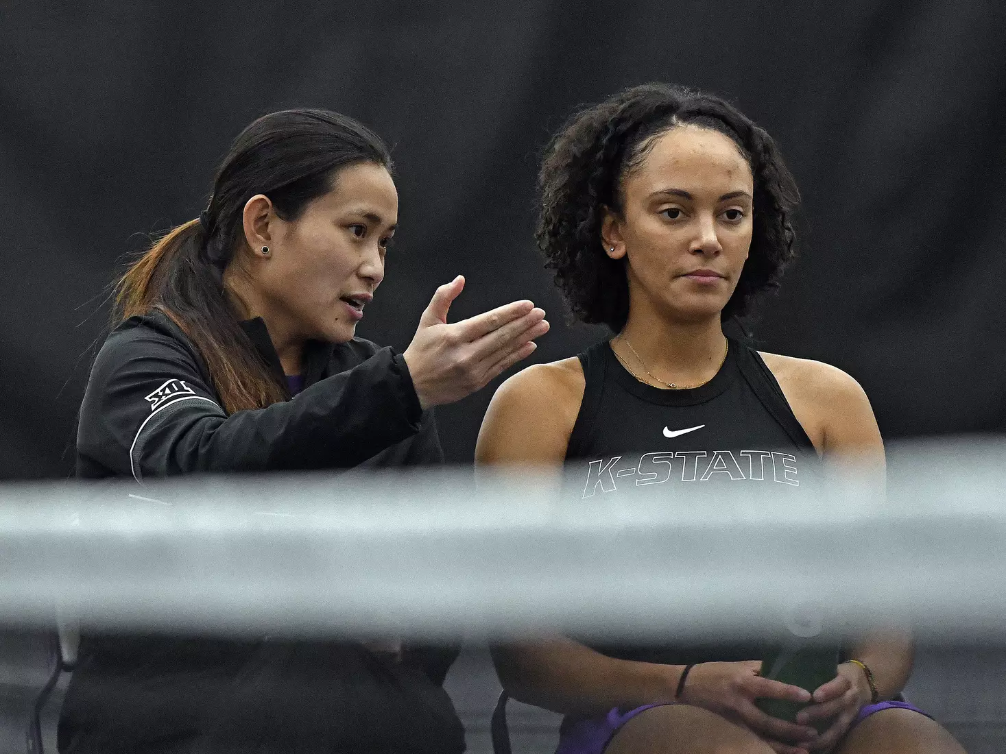 K-State’s coach Trang Huynh-McClain talks with Karine-Marion Job during the match against Memphis at the Body First Indoor Tennis Center in Manhattan, Kansas on February 11, 2022.