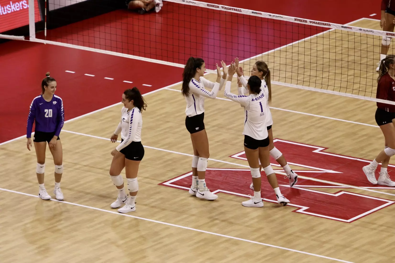 K-State celebrates a point against Colgate in the Husker Invitational on Friday.